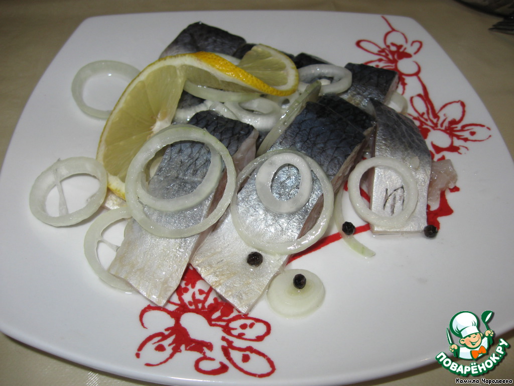 Homemade salted herring with lemon