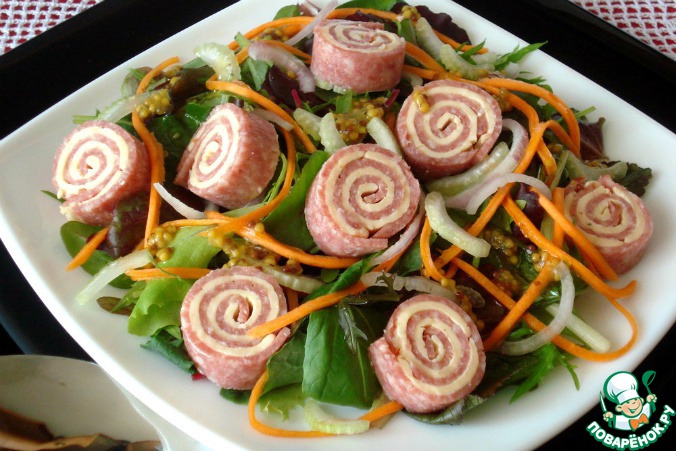 Salad mix with rolls of salami with cheese