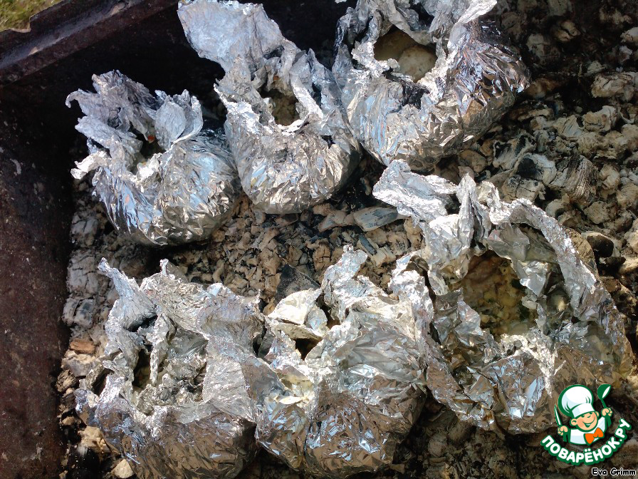 Chicken in foil on coals