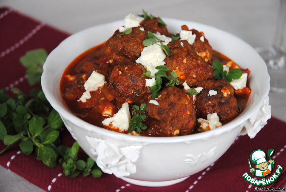 Meat balls in spicy tomato sauce with feta