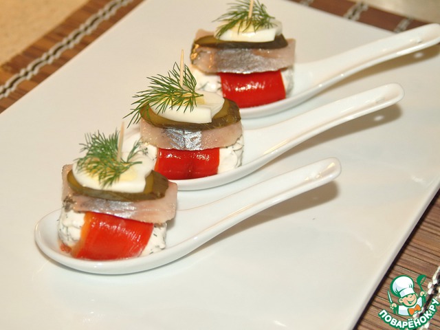 Appetizer of herring with pickled cucumber