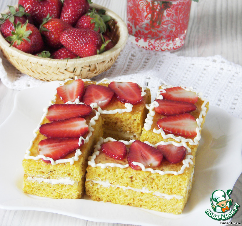 Airy carrot cake under a layer of juicy strawberries