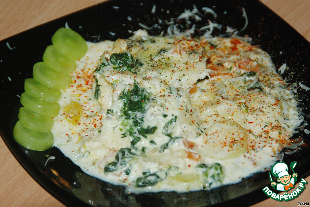 Fish in cheese sauce on vegetables