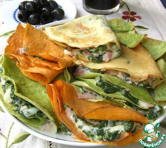 Colorful pancakes with spinach, cheese and ham