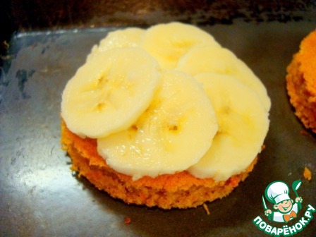 Pumpkin cakes with a banana under chocolate icing