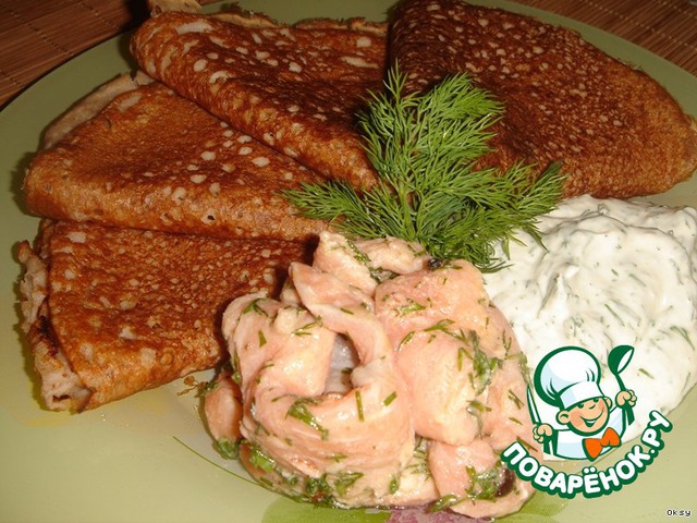 Buckwheat pancakes with salmon and sauce