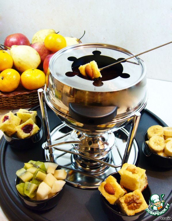 Chocolate fondue with chocolate biscuit and fruit