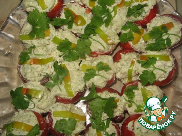 The tomatoes are stuffed with sausage cheese