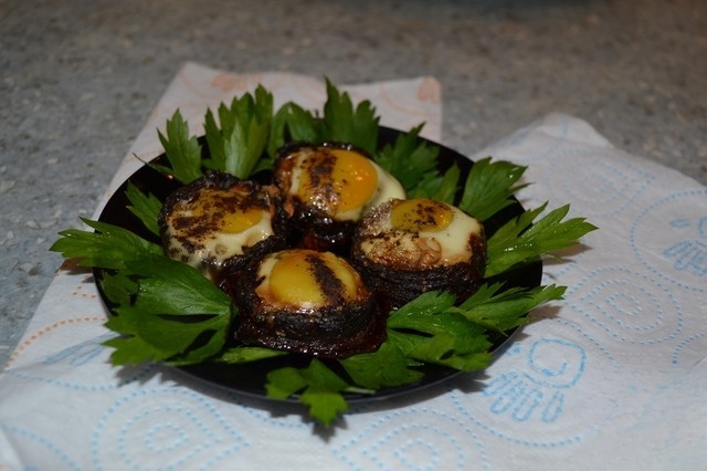 Quail eggs baked in mushroom caps