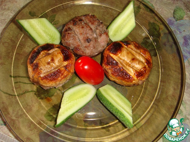 Champignons stuffed with meat on the grill