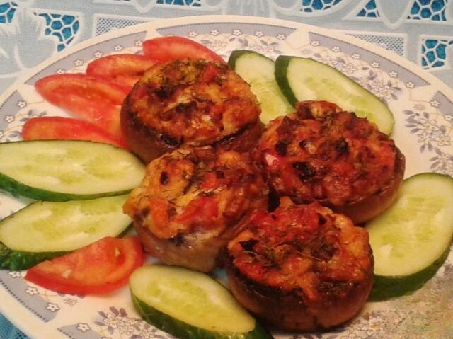 Mushrooms stuffed with vegetables and baked in the oven