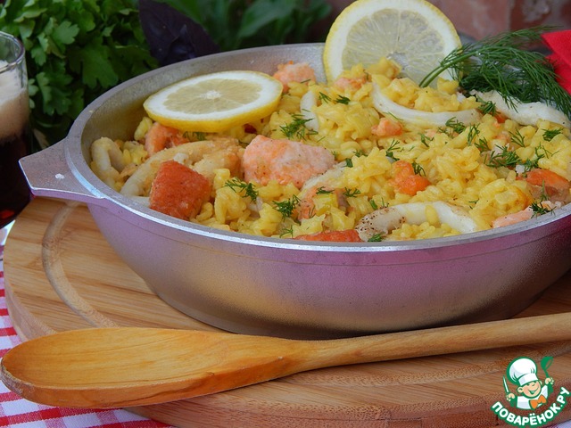 Paella on the beer with salmon and squid