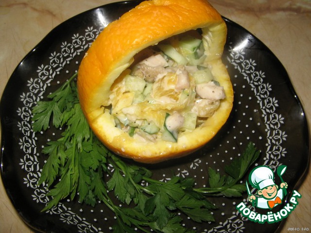 Chicken salad with oranges in a basket