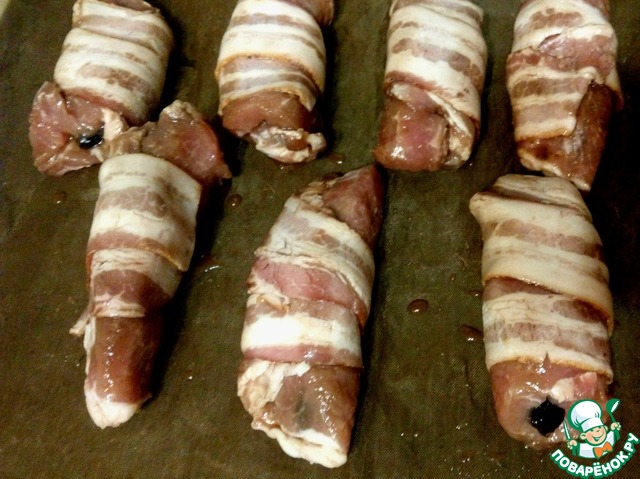 Rolls stuffed with prunes wrapped in bacon