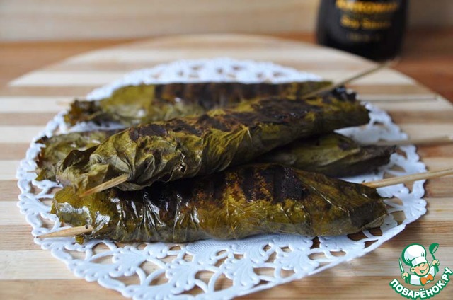 Salmon in grape leaves grilled