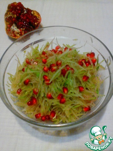 Salad from a green radish with pomegranate