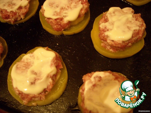 Meat patties on a platter of zucchini