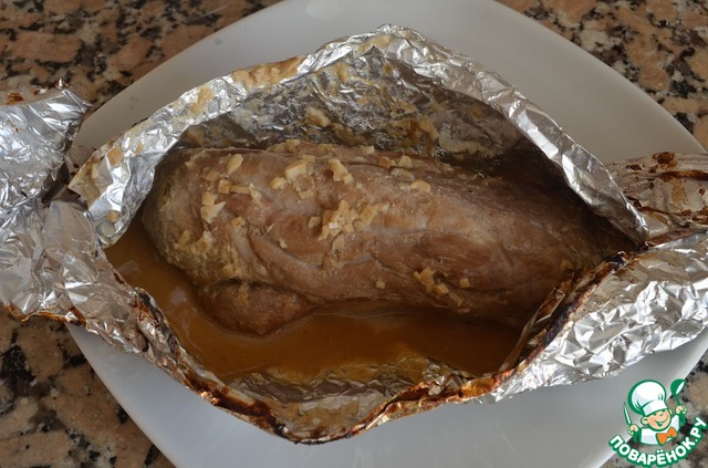 Pork tenderloin in foil on the coals