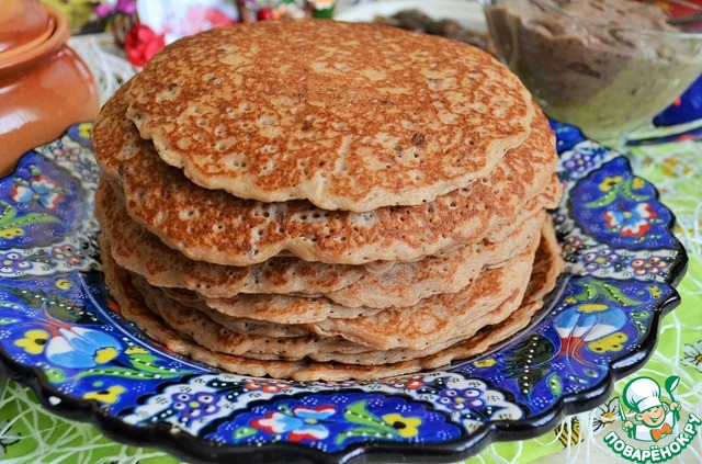 Buckwheat pancakes with sauce and mushrooms