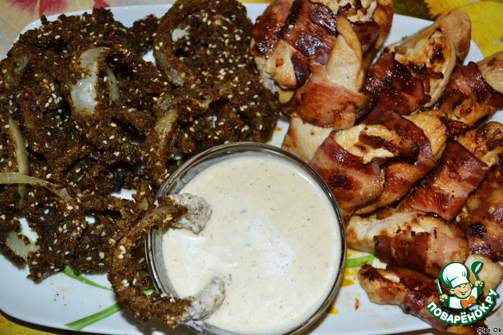 Chicken fillet in bacon with onion rings in soy sauce