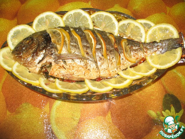Dorado in foil on a bed of vegetables