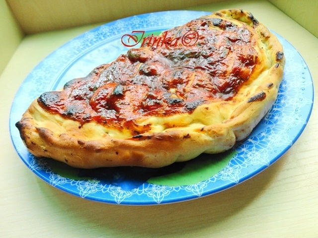 Pizza calzone with smoked sausages