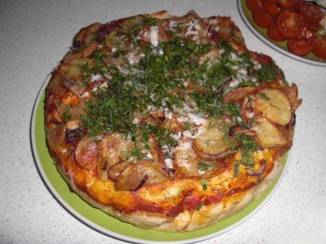 Thick pizza with potatoes and onions