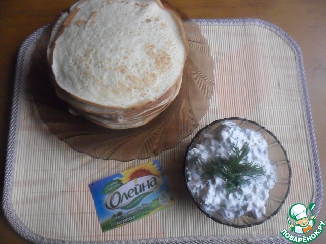 Sour cream pancakes with herring sauce