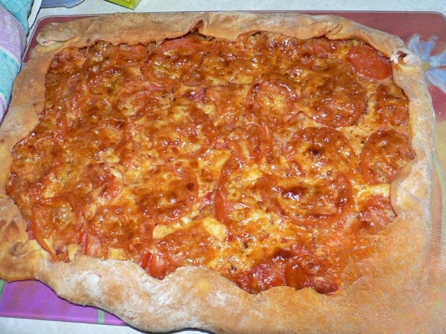 Pizza with sausage and all sorts of delicious additions