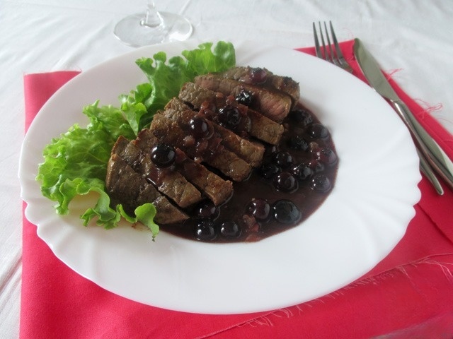 Beef steak with blueberry sauce