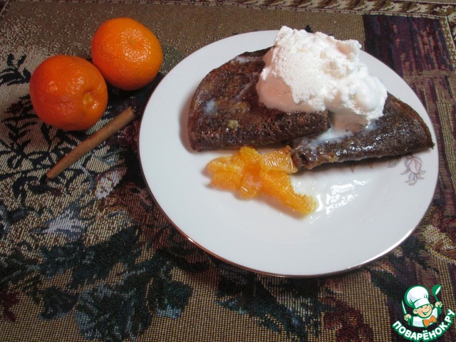 Chocolate pancakes with caramel and tangerines
