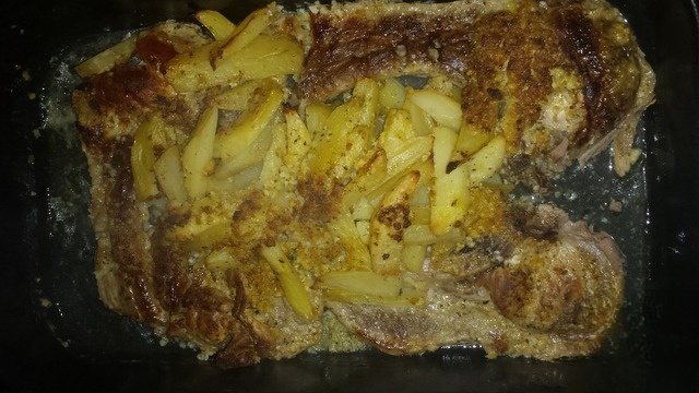 Pork steak with potatoes in Greek