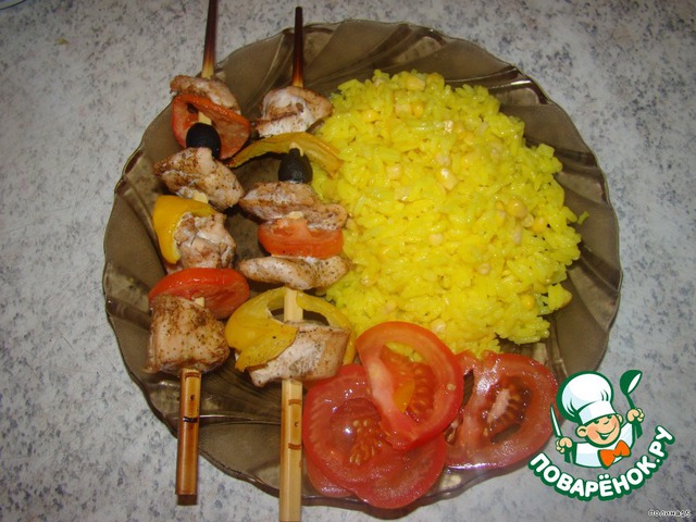 Chicken skewers and rice with corn