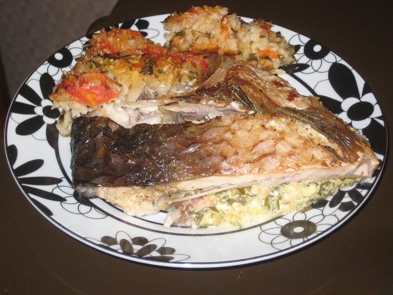 Fish stuffed with cheese and herbs, garnished with rice