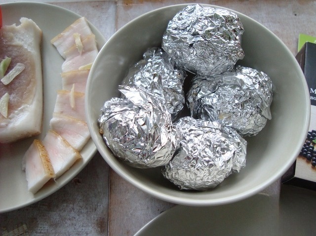 Baked potatoes with bacon in foil