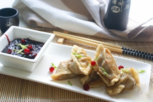Dumplings with duck and cranberry sauce in Chinese style