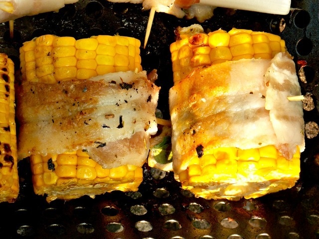Corn on the grill wrapped in bacon