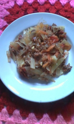 Stewed cabbage with meat and tomatoes