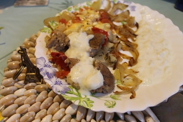 The beef in the pot with vegetables and onion sauce