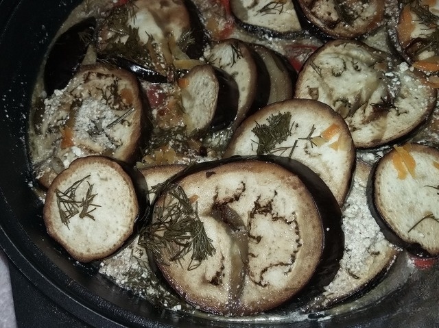 The chicken thighs under the eggplant